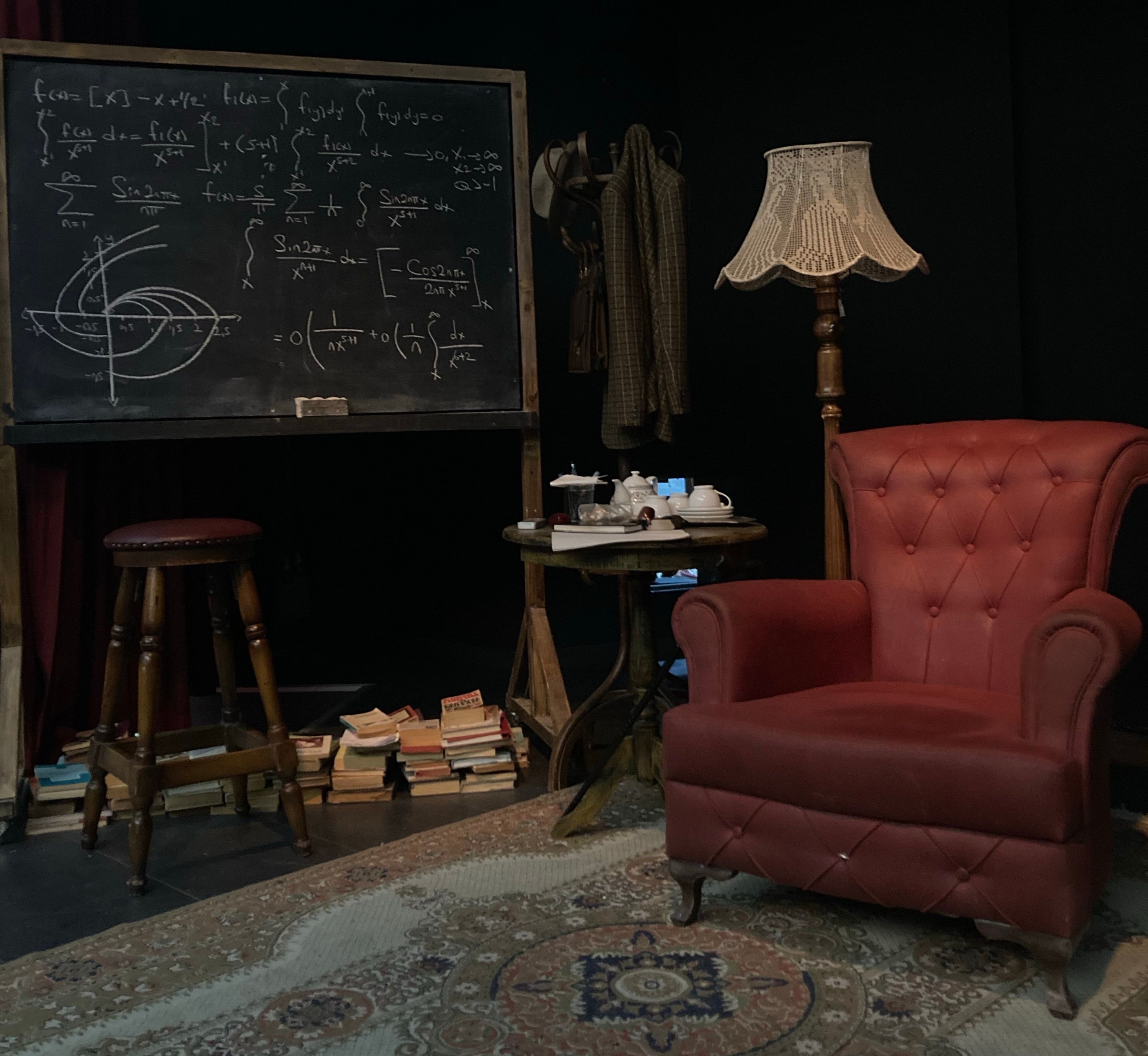 A classroom with a chalkboard and rows of desks